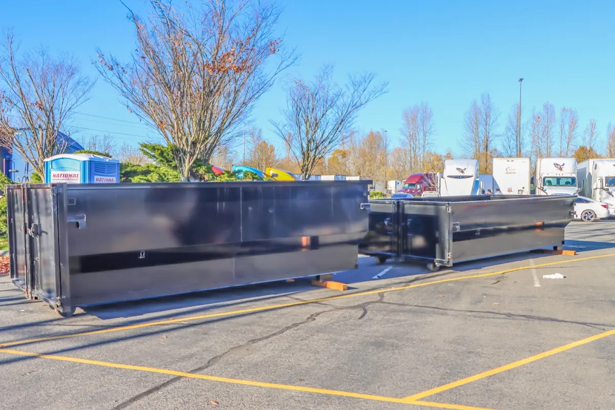 Professional dumpster rental service with roll-off container on residential driveway in Ironton